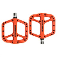 Oranžové mtb dh platformové pedále s ostrými kolíkmi Oranžové mtb dh platformové pedále s ostrými kolíkmi